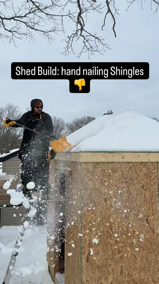 Hand-nailing shingles on the shed